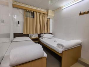 Un pat sau paturi într-o cameră la Jinnsti Guesthouse 景士迪宾馆