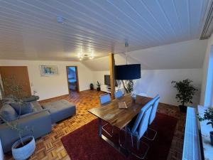 a living room with a table and a couch at Casa Italia in Oberasbach +18 photos