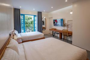 a hotel room with two beds and a desk at Spacious 6BR Villa Near Beach in Ha Long +41 photos