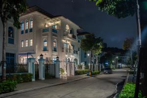 a white house with lights on a street at night at Spacious 6BR Villa Near Beach in Ha Long