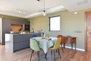 a kitchen and dining room with a table and chairs at Los Lagos 37 by VillaGranCanaria in Las Palmas de Gran Canaria