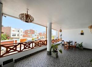 a room with a balcony with a view of a city at Hotel Pico Alto, La Planicie in Lima