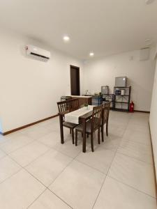 a dining room with a table and chairs at K-Avenue JANNATH269 HOMESTAY KKIA KK in Donggongon