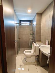 a bathroom with a toilet and a sink at K-Avenue JANNATH269 HOMESTAY KKIA KK in Donggongon