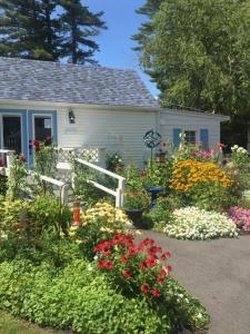 a garden of flowers in front of a house at 2 River Road Inn Cottages in Cape Neddick