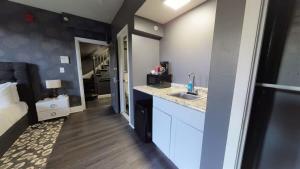 a small kitchen with a sink and a bedroom at Lower Level Studios In Hip Bay Village in Boston