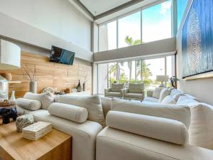 a large living room with a large white couch at Spectacular Ocean front 5BR condo in Bolongo in Punta Mita