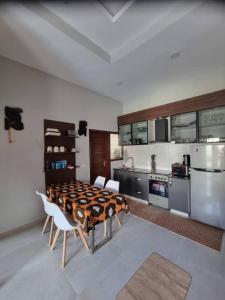 a kitchen with a table and chairs in a room at Aqua view Apartments in Bijilo