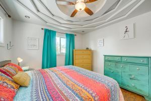 a bedroom with a ceiling fan and a bed at Artsy Cottonwood Stay with Hot Tub, Walk to Wineries in Cottonwood