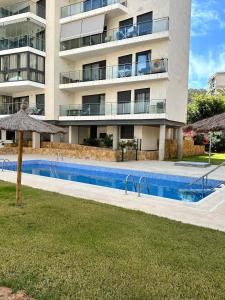 a swimming pool in front of a building at Luxurious, Newly-Renovated Large 2-Bedroom Condo by the Beach in Benidorm
