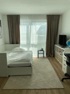 a bedroom with a white bed and a window at KG Apartment in Hannover +2 photos