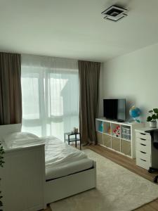 a bedroom with a bed and a dresser with a television at KG Apartment in Hannover