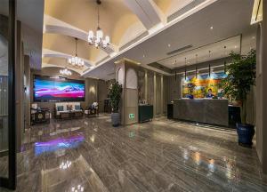 a lobby of a hotel with a large screen tv at Dm kara Rus Hotel - Muslim Street Branch in Xi'an