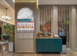 a drink station in a lobby with a blue cabinet at Dm kara Rus Hotel - Muslim Street Branch in Xi'an