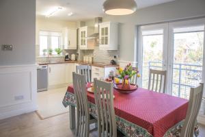 a kitchen and dining room with a table and chairs at Connemara Letting's Townhouse in Clifden
