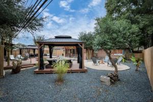 a gazebo with a table and chairs in a yard at Heated Pool Retreat OutdoorTV BBQ and Cozy Gazebos in Houston