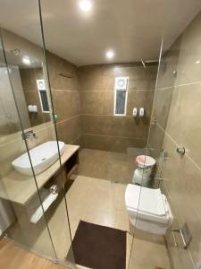 a bathroom with a toilet and a sink at HOTEL EVERSHINE in Rajkot