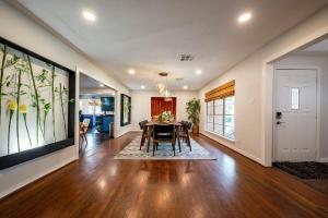 a dining room with a table and a large painting on the wall at Heated Pool Retreat OutdoorTV BBQ and Cozy Gazebos in Houston