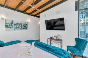 a bedroom with a bed and a tv at Resort Style Vacay HeatedPool Hottub and Cabanas in Houston