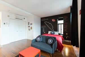 1 dormitorio con 1 cama con manta roja y silla azul en The Grand Prix Suite In the heart of MTL - M11 Rentals, en Montreal