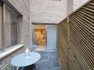 un patio con una mesa blanca y una ventana en DFLAT Escultor Madrid Apartments, en Madrid