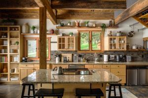 a kitchen with wooden cabinets and a large island at Evergreen Castle - SLEEPS 8 - Close to skiing in Evergreen