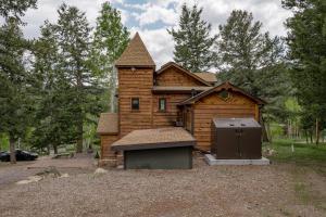 a log cabin with a stove in front of it at Evergreen Castle - SLEEPS 8 - Close to skiing in Evergreen