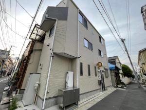 a building on the side of a street at QiQi Serenity Tokyo Exclusive New 3-Story Home, 14min to Skytree, Asakusa Area in Tokyo