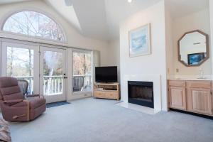a living room with a fireplace and a television at Tidewater- Teal lake #2521 in North Myrtle Beach