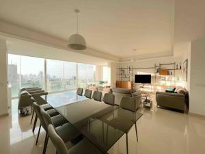 a living room with a glass table and chairs at Gorgeous 3Br Achrafieh Apt in Beirut