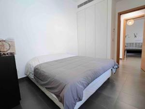 a bedroom with a bed in a white room at Gorgeous 3Br Achrafieh Apt in Beirut