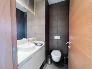 a bathroom with a sink and a toilet at Gorgeous 3Br Achrafieh Apt in Beirut