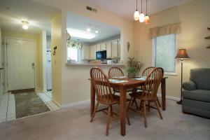 a dining room and kitchen with a table and chairs at Teal Lake 2323 in North Myrtle Beach