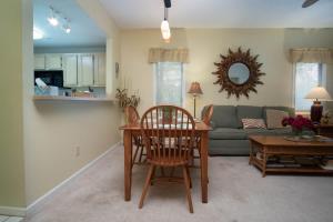 a living room with a table and a couch at Teal Lake 2323 in North Myrtle Beach