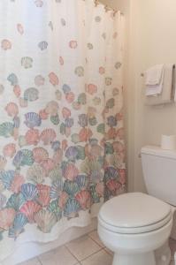 a bathroom with a toilet and a shower curtain at Tidewater Teal Lake 1323 in North Myrtle Beach