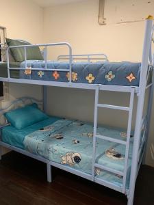 two bunk beds in a room with a bed at Green Apple Hostel Khaosan in Bangkok
