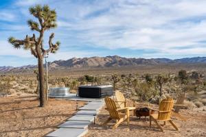 um grupo de cadeiras e uma mesa no deserto em Kinetic House-Joshua Trees Sculptures Cowboy Pool em Yucca Valley