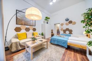 a living room with a bed and a couch at Diamond Residence - BimBam Bajza in Budapest
