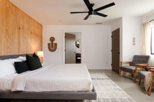 a bedroom with a bed and a ceiling fan at Harmony Tea House on El Dorado in Yucca Valley