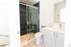 a bathroom with a shower and a toilet and a sink at Chalet Luméo in Brownsburg +27 photos