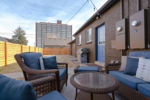 a patio with wicker chairs and a table at 4-Bed Gem near Sloan's Lake in Denver