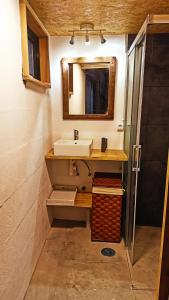 a bathroom with a sink and a mirror at A Cabaña do Cumiar in Ponteareas +35 photos
