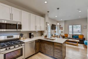 a kitchen with stainless steel appliances and a living room at Lake View Lodge Gateway To The Rockies Sleep 6 in Georgetown