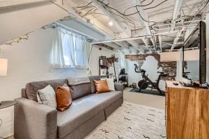 a living room with a couch in a room at Redbrick Cottage 2BDRM Wash Park Yard & Gym in Denver