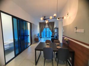 a dining room with a black table and chairs at Reizz Homestay By Classy in Kuala Lumpur