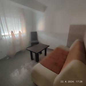 a living room with a couch and a table at Apartman Numero Uno in Vogošća