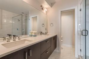 a bathroom with a sink and a large mirror at 4BR Upscale Townhome Roof Top w Skyline Views in Denver +17 photos