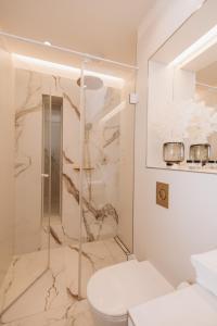 łazienka z toaletą i przeszklonym prysznicem w obiekcie Stylish new apartment in Prague with A/C w Pradze
