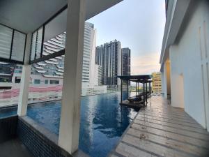 a swimming pool on the roof of a building at Reizz Homestay By Classy in Kuala Lumpur
