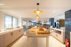 a bakery with a table with bread on it at Aqualuz Lagos by The Editory in Lagos